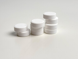 Pills close-up on a light background. Taking vitamins or medications. Concept of healthcare, medicine, pharmacy, disease prevention  