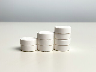 Pills close-up on a light background. Taking vitamins or medications. Concept of healthcare, medicine, pharmacy, disease prevention  