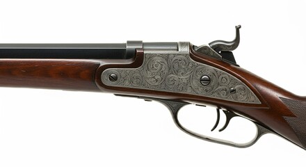 Closeup of an antique rifles intricately engraved receiver and trigger guard. The dark wood stock contrasts with the silver engraving. A percussion cap firearm.
