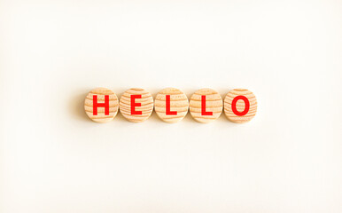Hello symbol. Concept word Hello on beautiful wooden circles. Beautiful white table white...