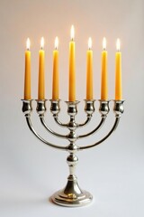 Golden Hanukkah candles glow brightly in a silver candelabrum on white background, white, light, hanukkah
