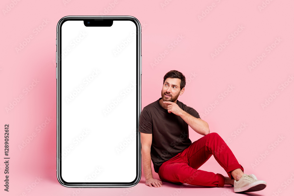 Poster full size photo of minded man dressed brown t-shirt sit look at smartphone touchscreen empty space i