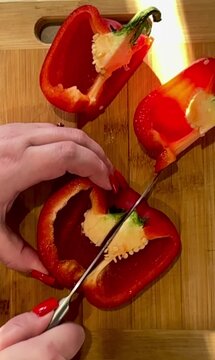 Red bell pepper cut into pieces. Close-up.