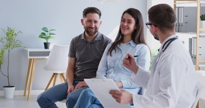 Happy family couple during a consultation with a gynecologist doctor, discussing pregnancy planning or ivf. They are at the hospital seeking advice and assistance with family planning journey.