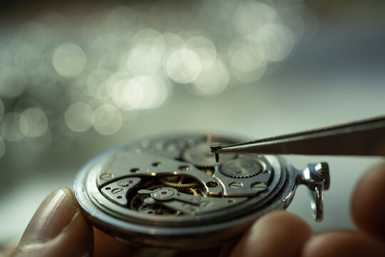 watchmaker repairing classic mechanical watch movement