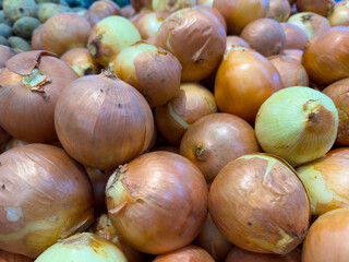Piles of onions are sold in traditional markets