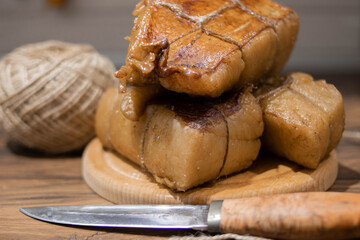 Smoked lard on a wooden board with a knife for cutting