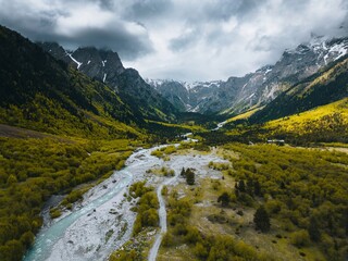 valley with steep mountains, flight over a mountain river, aerial view