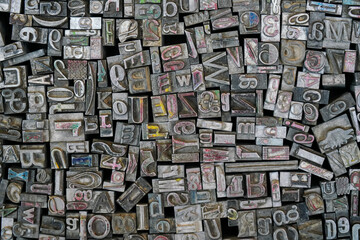 Pile of various metal letter press blocks