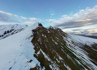 high relief mountains covered with snow, mountain range, aerial view drone shot