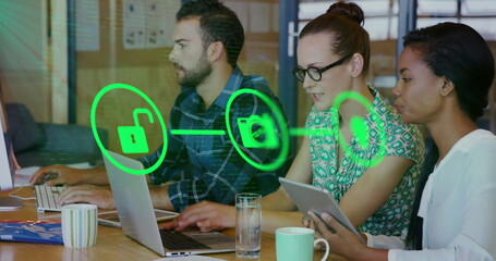 Image of network of connections with icons over diverse colleagues working in office