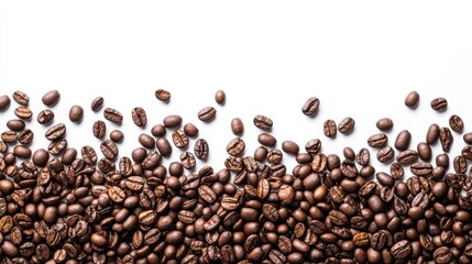 Obraz premium A stunning arrangement of rich, dark roasted coffee beans scattered elegantly on a white background.
