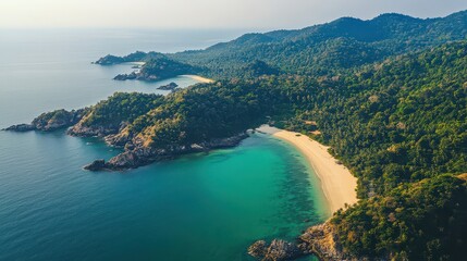 Obraz premium A top-down view of the southern Thai coastline, where emerald water meets sandy beaches and dense jungle-covered hills.