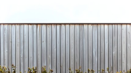 Weathered Wooden Fence in Outdoor Setting with Greenery at the Base Under Clear Sky