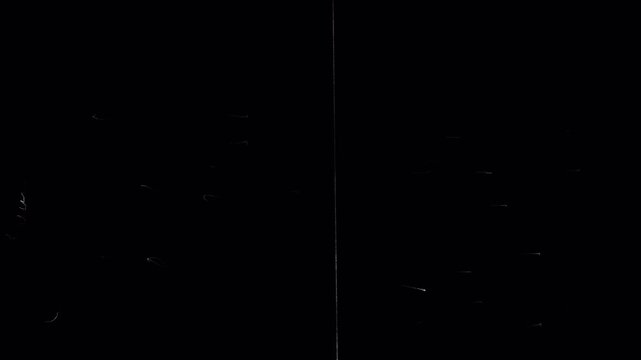 White retro streaks and scuffs on black film. Stock video with an old effect for overlay, featuring scratches and damage.