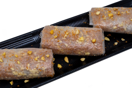 Pootharekulu putharekulu pootarekulu PNG – Famous South Indian Andhra Sweet with Crispy Rice Paper, Jaggery and Nut toppings transparent background