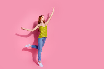 Full body portrait of nice young lady dancing empty space ad wear shiny top isolated on pink color background