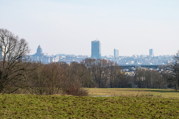 View over green farmland with the city landmarks in the background in Dilbeek, Flemish Brabant,...