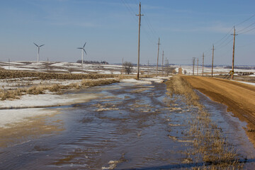 water from spring snow melt running down the road ditch