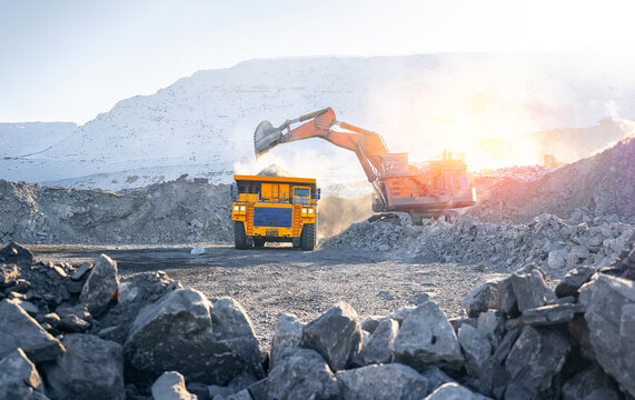 Big yellow mining truck at work open pit mine. Transport coal from factory production, sunlight