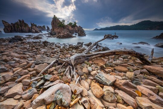 Landscape and seascape of rocky beach at Shark Tooth Beach Kelumbayan Lampung