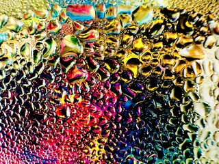Close-up of water drops on metal surface in high resolution showing condensation of water droplets on metal surface. Intricate patterns and different sized water droplets create a beautiful abstract