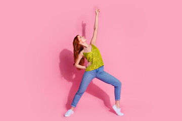 Full size photo of pretty young woman dancing wear shiny top isolated on pink color background