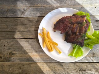 fried ribs on a white plate. High-quality photos