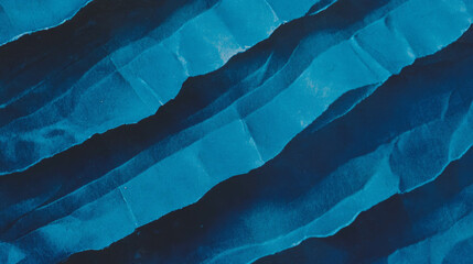 Obraz premium Dramatic deep wavy ribbed blue paper texture for artistic design and background use