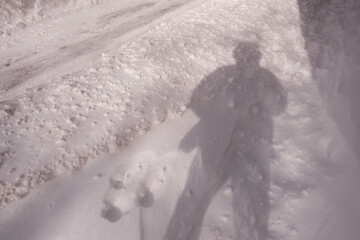 Shadow of a man on a snow-covered ground