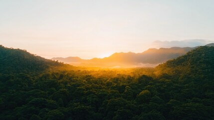 Golden sunrise illuminates lush mountains, creating serene lands