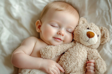 Baby sleeping peacefully embracing a teddy bear in bed