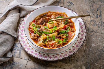 Healthy cabbage soup with meatballs, mushrooms and green onions, sauerkraut soup