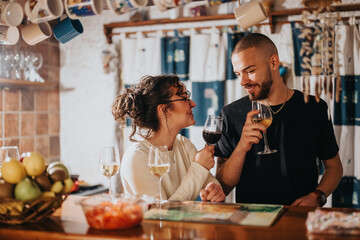 A warm and joyful moment shared by a couple while drinking wine at a bar. The atmosphere is inviting and the environment reflects intimacy and relaxation, complemented by soft lighting and decor.