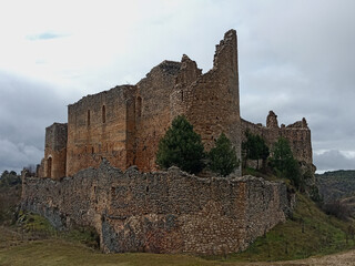 Ancient Templar castle ruins in Ucero, Spain, under a dramatic sky