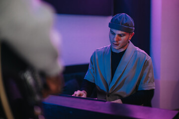 A focused musician is engrossed in creating music in a dynamic recording studio. The atmosphere is...