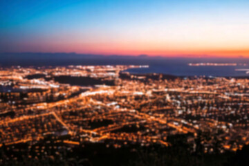 The lights of the night city. Blurred background. Lanterns on the street. big city lights in the twilight evening with blurring. Colorful circles of light abstract. circular bokeh on blue horizon.