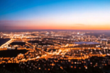 The lights of the night city. Blurred background. Lanterns on the street. big city lights in the twilight evening with blurring. Colorful circles of light abstract. circular bokeh on blue horizon.