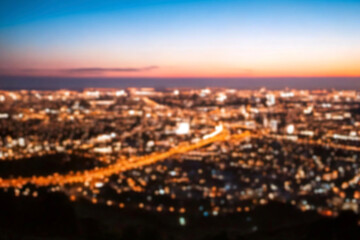 Obraz premium The lights of the night city. Blurred background. Lanterns on the street. big city lights in the twilight evening with blurring. Colorful circles of light abstract. circular bokeh on blue horizon.
