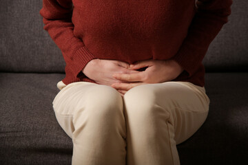Stomach pain. Woman having upset stomach or menstrual cramps. A young woman experiences abdominal...