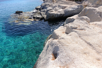 Picturesque seaside area and bay of Goupa - Karra with colourful boat houses a perfect place to swim, Kimolos island, Cyclades, Greece