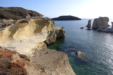 Fototapeta premium Paradise sandy organised beach of Mavrospilia with white rock formations best place to see the sunset in the island of Kimolos, Cyclades, Greece