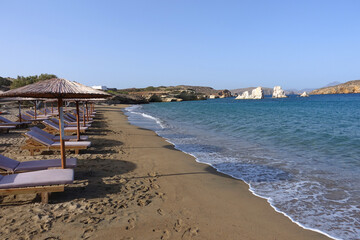 Fototapeta premium Paradise sandy organised beach of Mavrospilia with white rock formations best place to see the sunset in the island of Kimolos, Cyclades, Greece