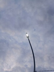White Street Lamp under a Cloudy Early Morning Sky