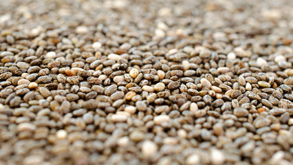 Heap of chia seeds as background, texture, above. Pile of healthy chia seeds, background, texture, close-up. Heap of chia seeds close-up, background, texture, top view.