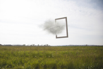 frame suspended between sky and earth crossed by a cloud, concept of freedom