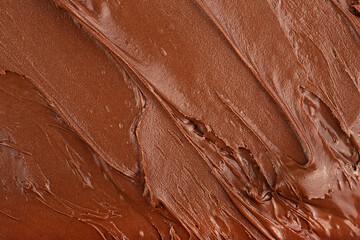 Melted chocolate cream as background, top view. Hazelnut cream, chocolate smear.