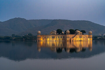 India. Rajasthan. Jaipur. Jal Mahal, the stunning Water Palace reflecting on the serene waters of...