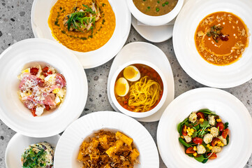 A vibrant arrangement of various delicious dishes including pasta, risotto, salads, and soups,...