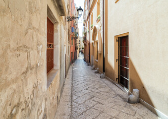 Fototapeta premium A narrow cobblestone street in the historic center of Trapani, Sicily, Italy